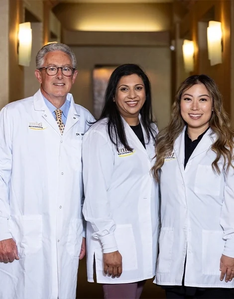 Dr. Williams, Dr. Alex and Dr. Woo-Hewitt in the corridor of Main Line Dental Group.