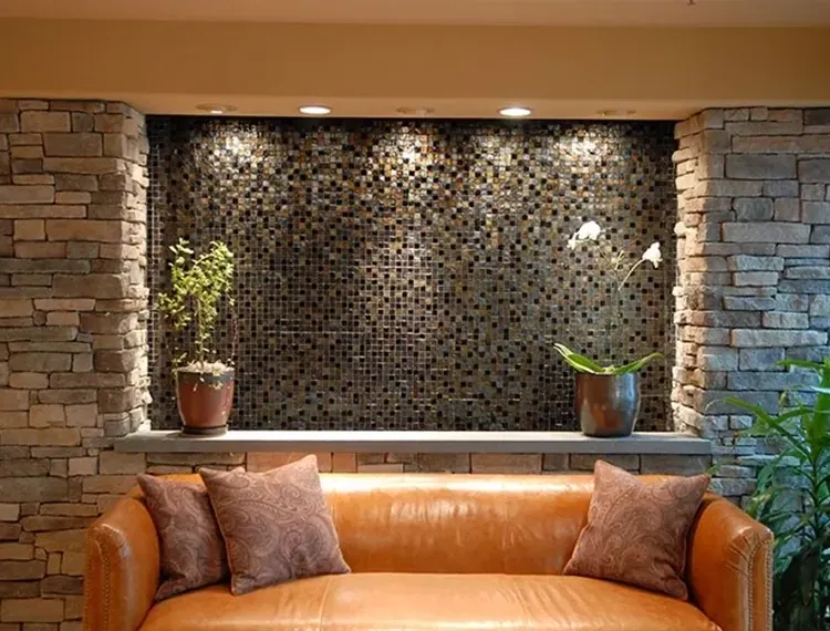 The leather sofa and mosaic stone wall in the lobby.